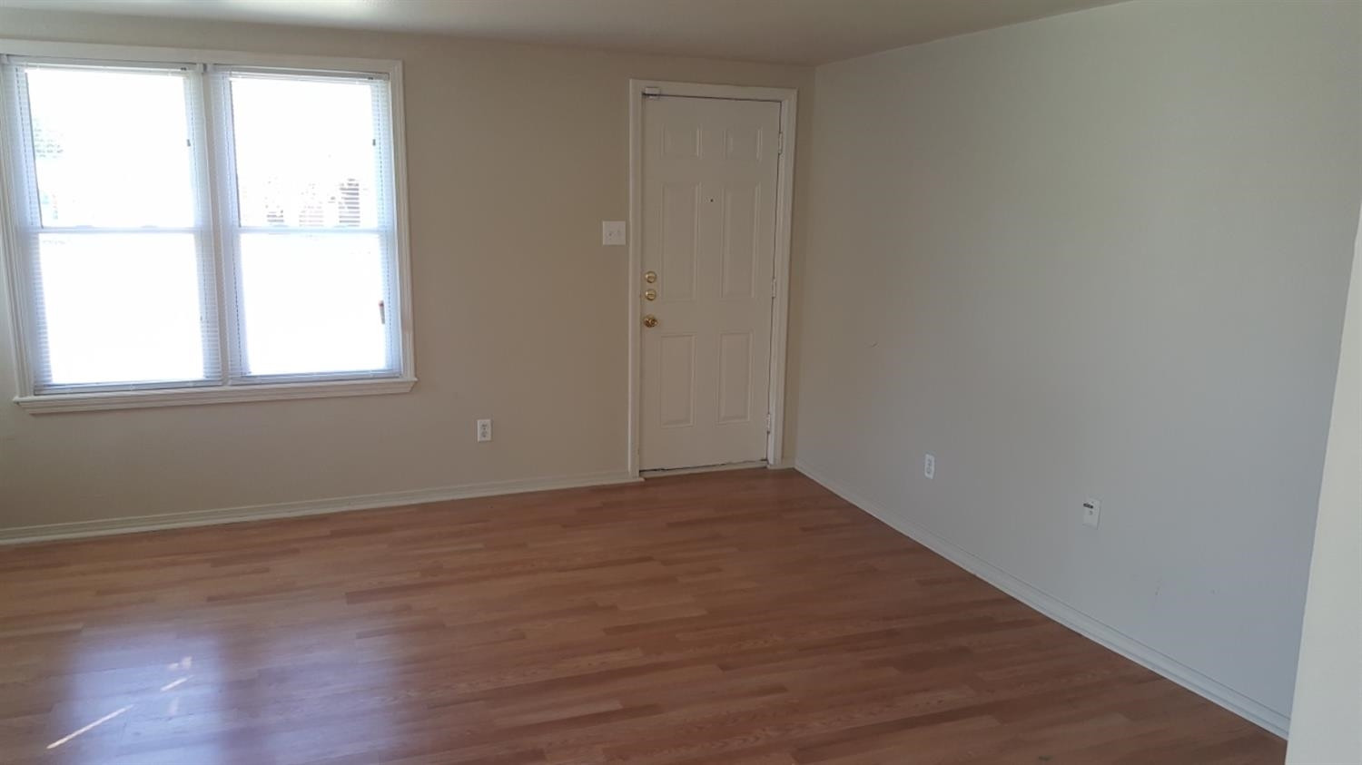 1807 18th Street Lubbock, TX 79401 - Photo 19 of 27 an empty room with wooden floor and windows