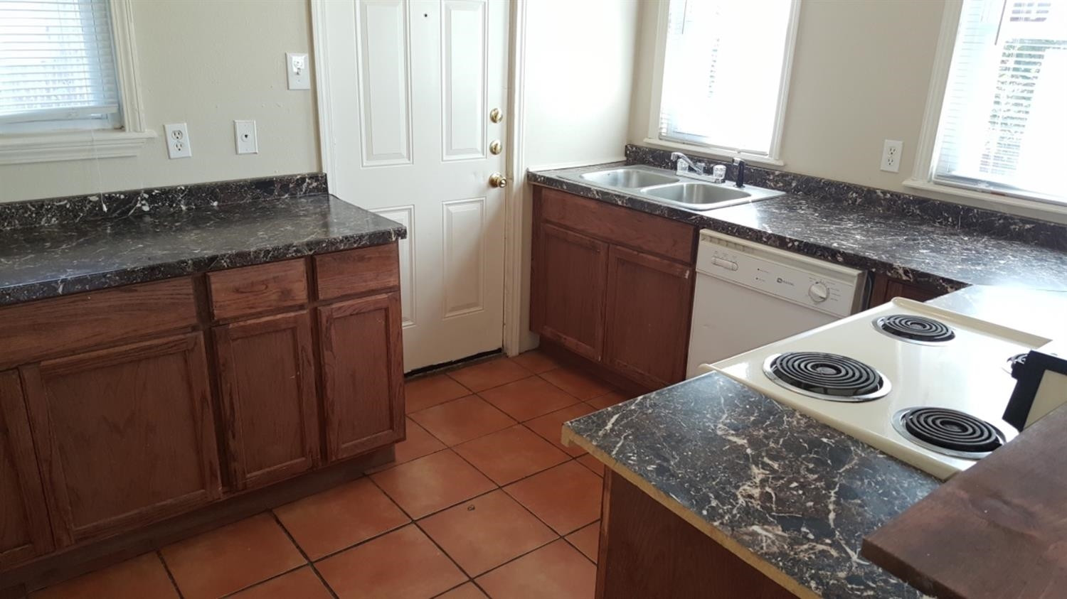 1807 18th Street Lubbock, TX 79401 - Photo 20 of 27 a kitchen with a sink stove and cabinets