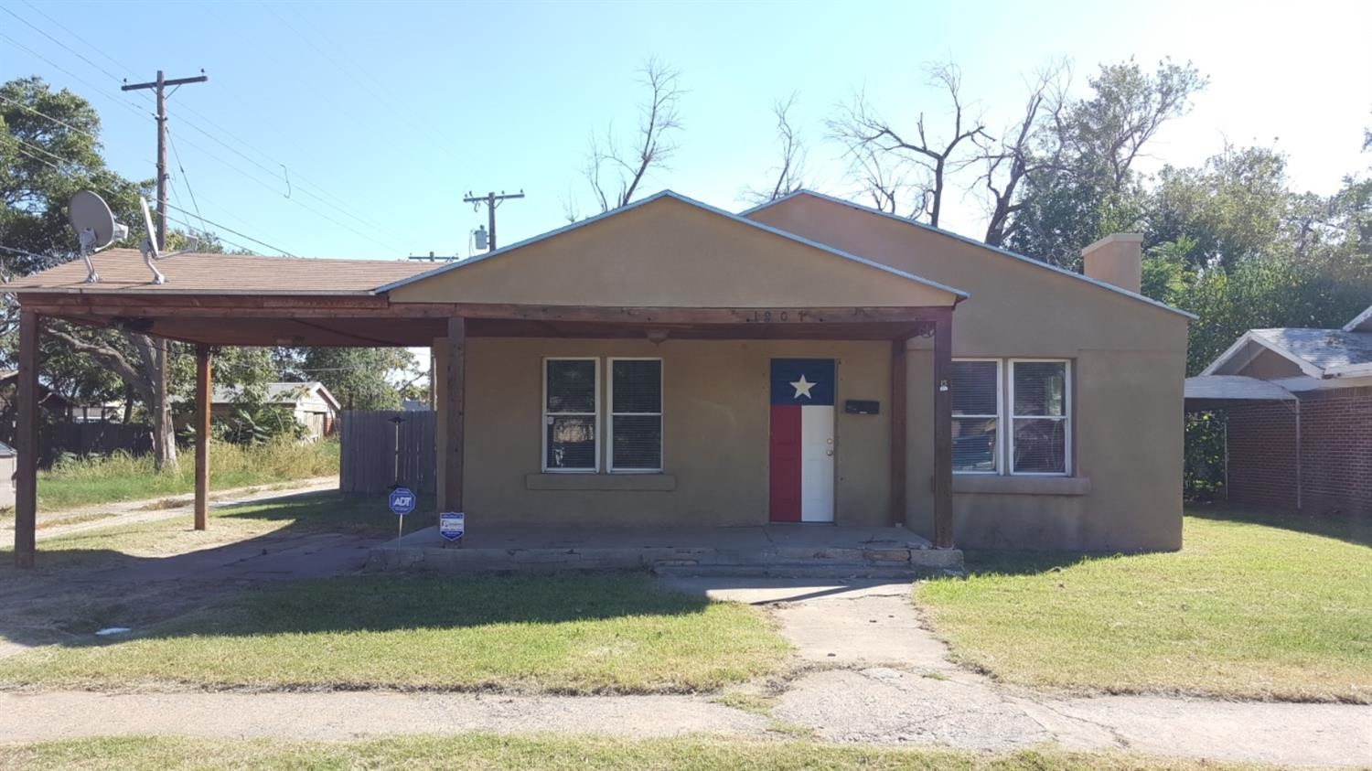 1807 18th Street Lubbock, TX 79401 - Photo 2 of 27 a front view of a house with a yard
