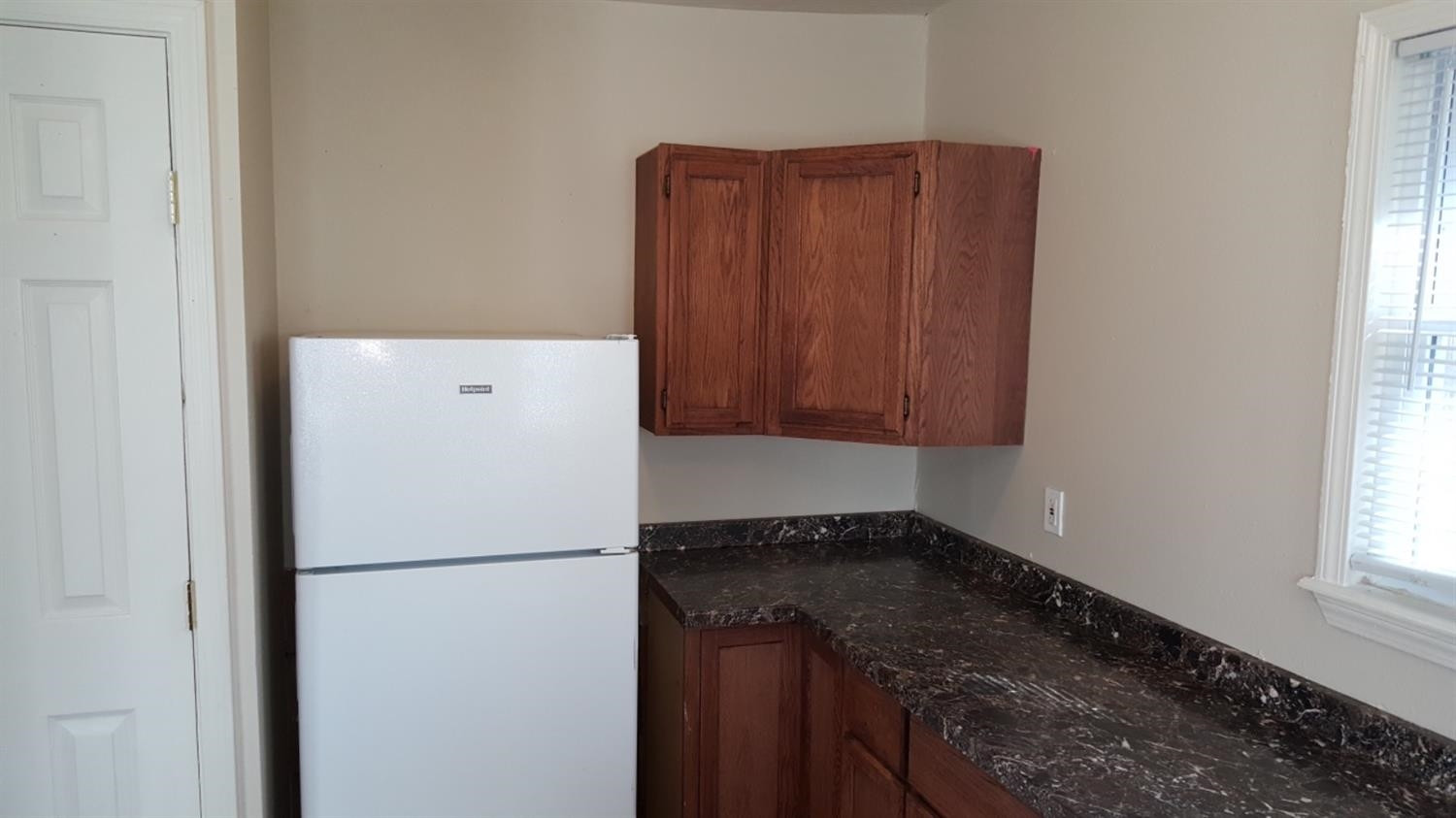 1807 18th Street Lubbock, TX 79401 - Photo 26 of 27 a white refrigerator freezer sitting inside of a kitchen