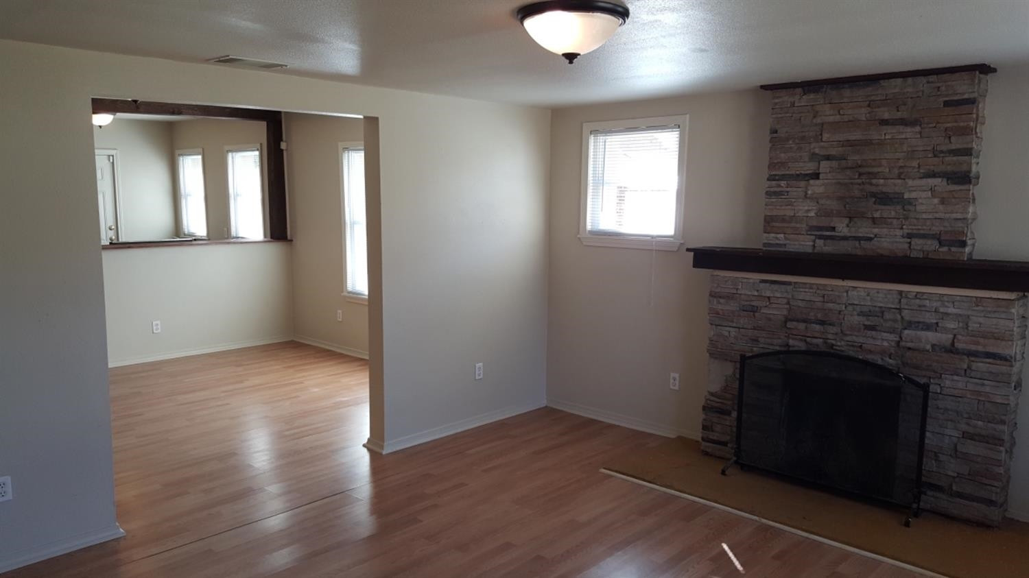 1807 18th Street Lubbock, TX 79401 - Photo 5 of 27 an empty room with windows and fireplace