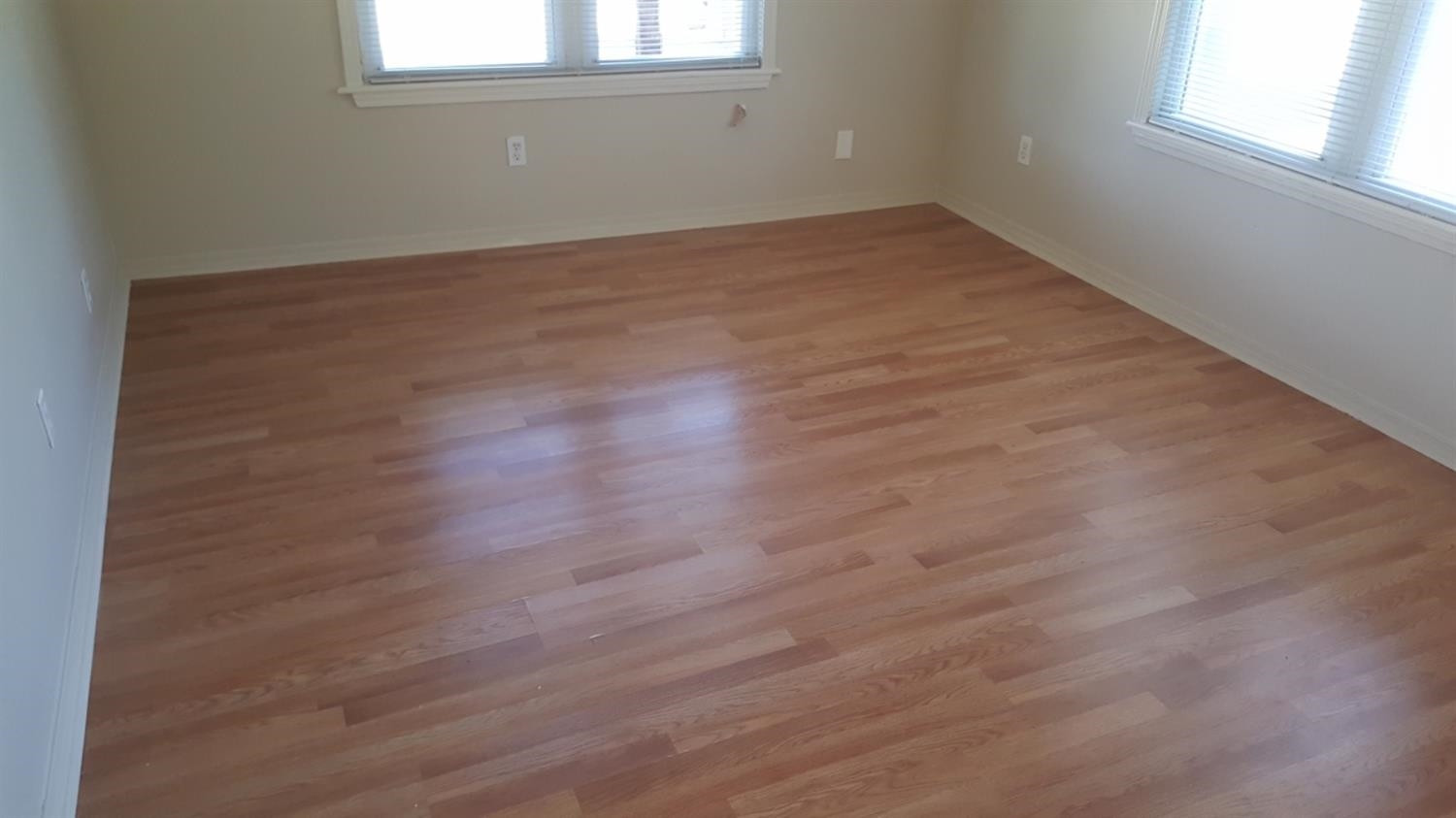 1807 18th Street Lubbock, TX 79401 - Photo 8 of 27 an empty room with wooden floor and windows