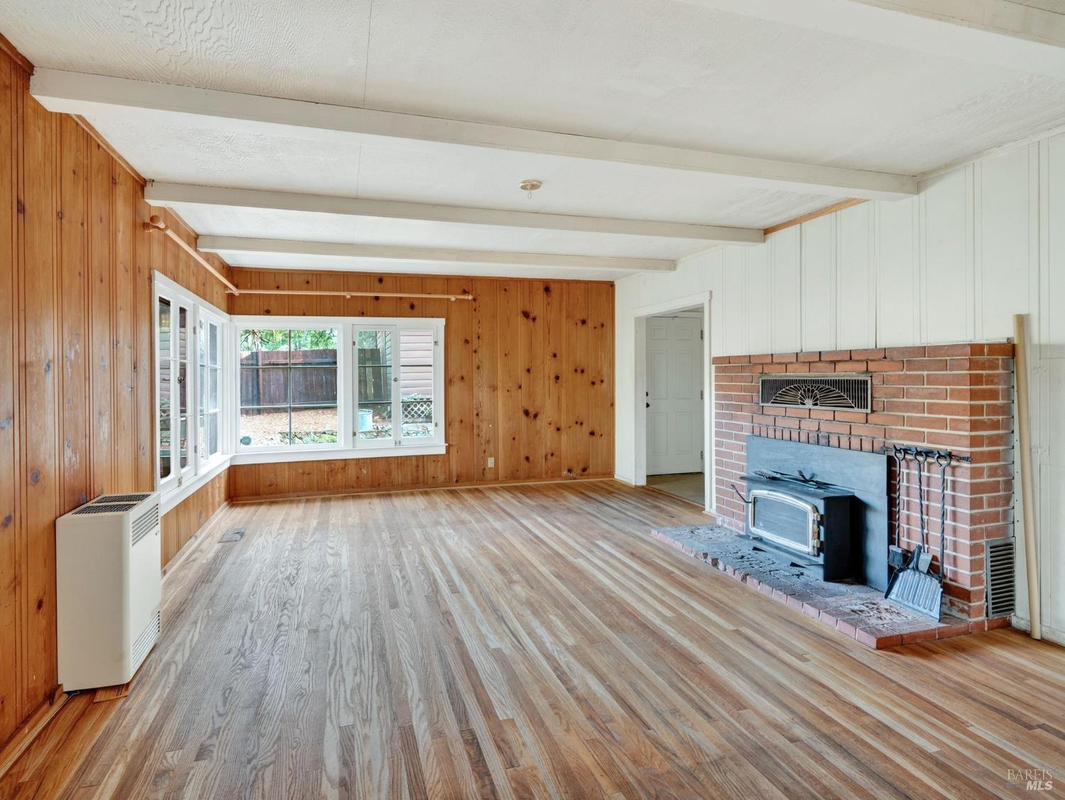 10701 Orr Springs Road Ukiah, CA 95482 - Photo 8 of 52 wooden floor fireplace and windows in an empty room