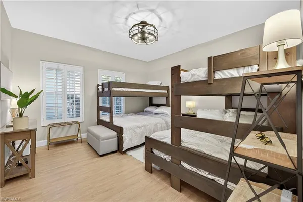 a bedroom with furniture and wooden floor