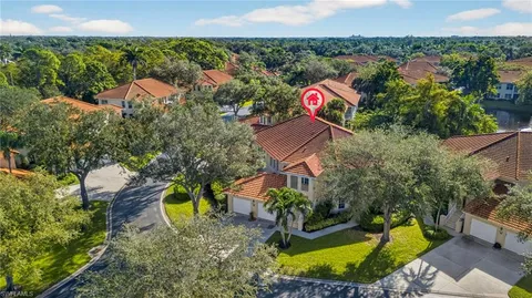 an aerial view of a house with swimming pool and garden