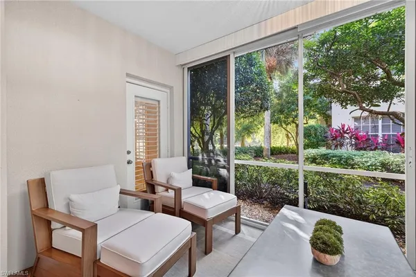 a living room with furniture and a garden