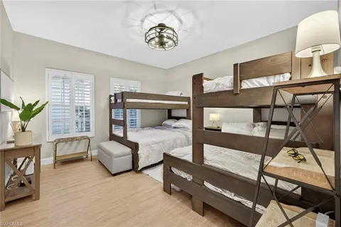 a bedroom with furniture and wooden floor