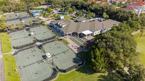 an aerial view of a house with a swimming pool and outdoor seating