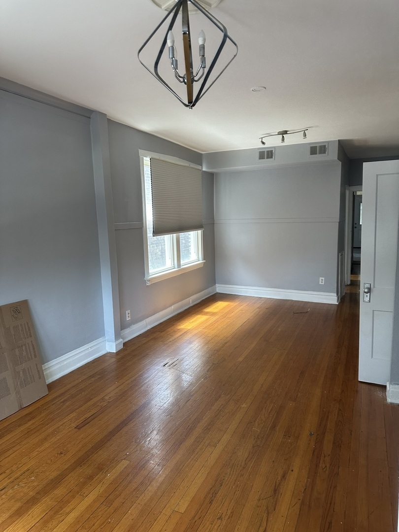 6546 South Rockwell Street, Unit 2 Chicago, IL 60629 - Photo 2 of 11 a view of empty room with wooden floor and fan