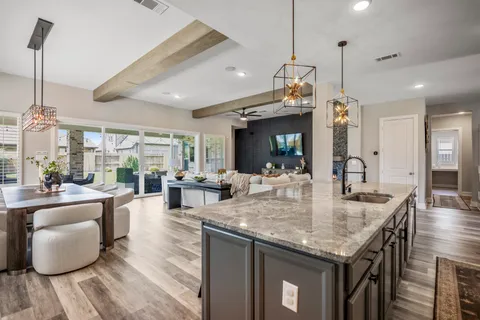 a kitchen with granite countertop living room and living room