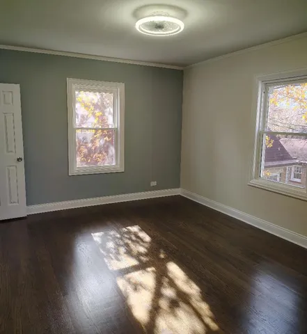 a view of an empty room and wooden floor