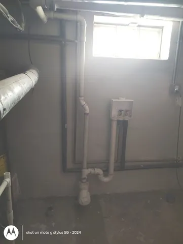 a large white kitchen with cabinets and a window