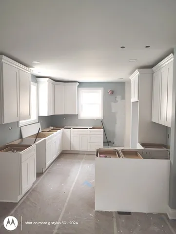 a kitchen with a sink a stove and cabinets