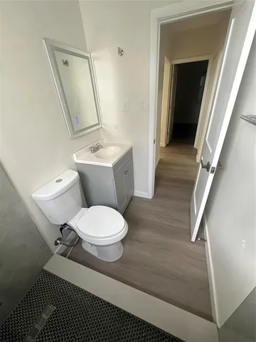 a white toilet sitting next to a bathroom sink