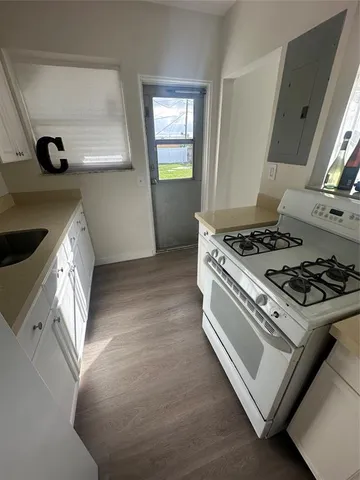 a kitchen with granite countertop a stove and a sink