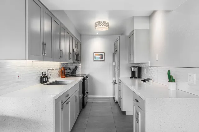a kitchen with a sink stove and refrigerator