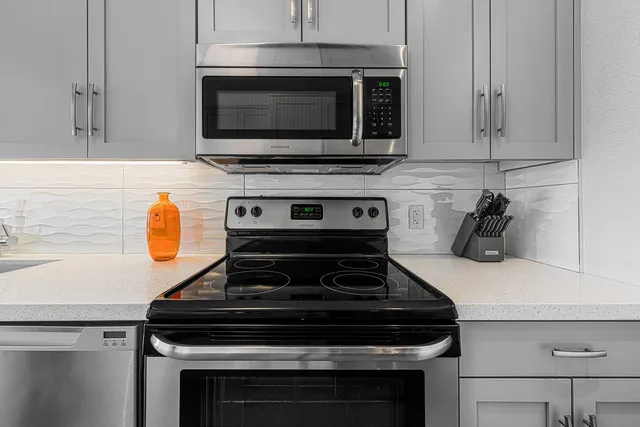 a stove top oven sitting inside of a kitchen