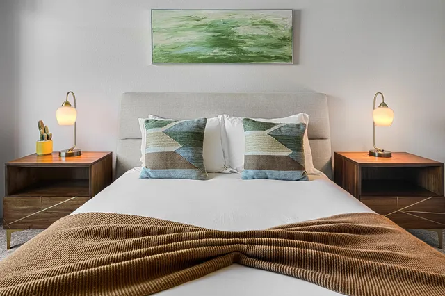 a bedroom with a bed and a lamp