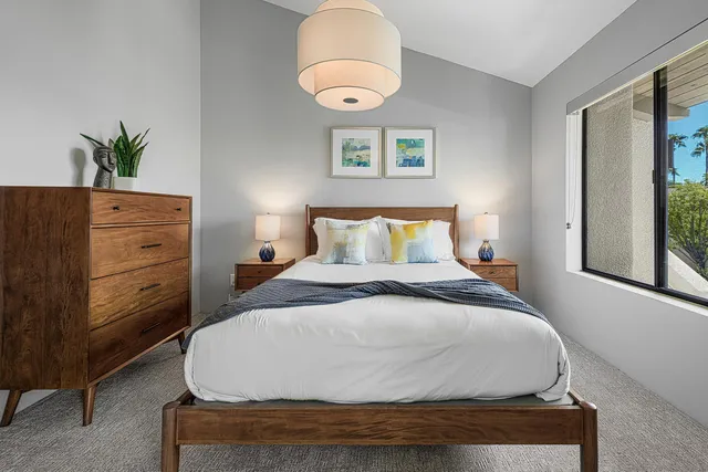 a bedroom with a bed and window