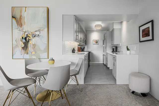 a view of a dining room with furniture and a chandelier