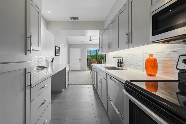 a kitchen with stainless steel appliances a stove sink microwave and cabinets