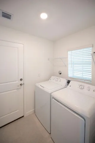 a view of storage and utility room with washer and dryer