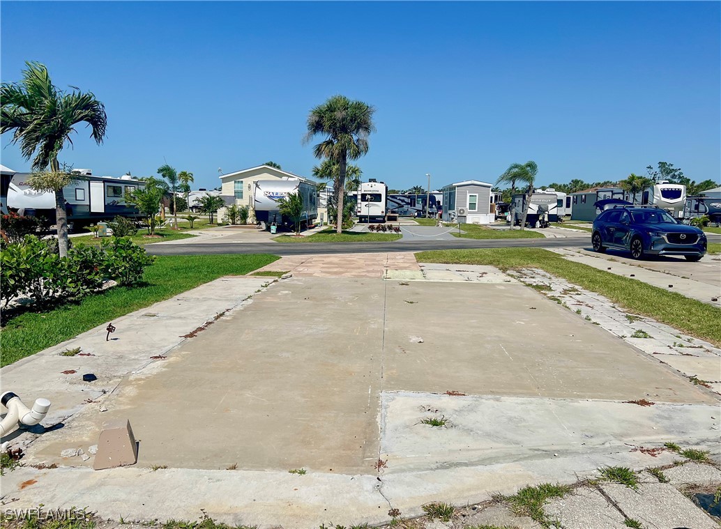 19681 Summerlin Road, Unit 211 Fort Myers, FL 33908 - Photo 4 of 21 a view of yard with car parked
