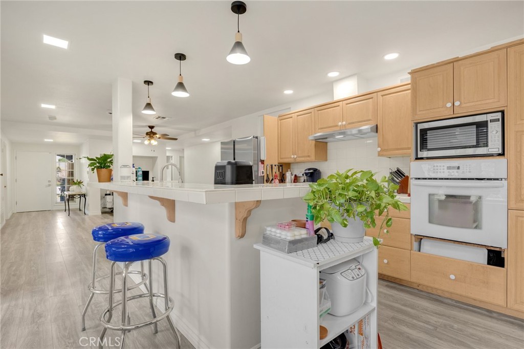 358 Lotus Place Brea, CA 92821 - Photo 14 of 31 a living room with furniture a fireplace and a chandelier