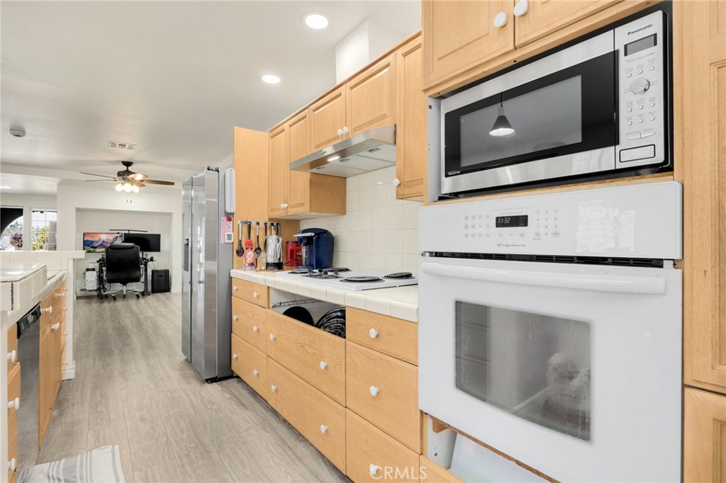 358 Lotus Place Brea, CA 92821 - Photo 15 of 31 a kitchen with stainless steel appliances granite countertop a stove microwave and cabinets
