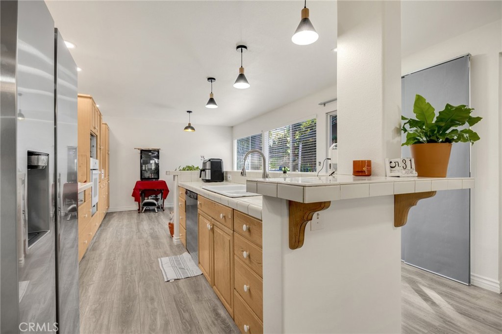 358 Lotus Place Brea, CA 92821 - Photo 9 of 31 a kitchen with furniture a counter top space a sink and a refrigerator