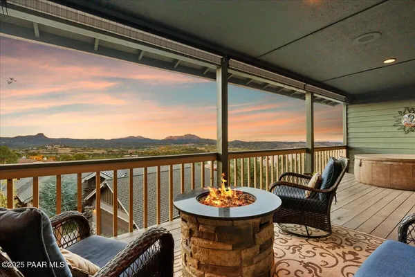 a living room with furniture floor to ceiling window and flat screen tv