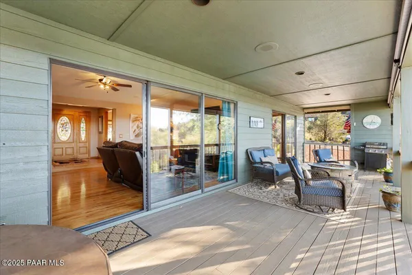 a view of a workspace with furniture and a flat screen tv