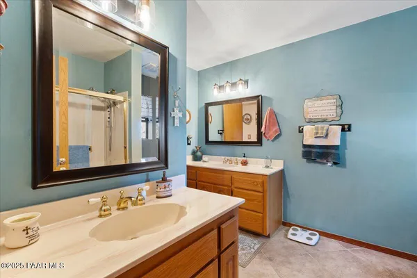 a bathroom with a double vanity sink and a mirror