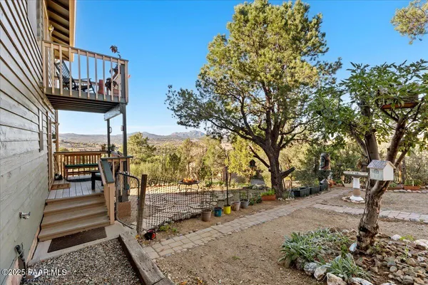 an aerial view of a house with swimming pool garden view and trees