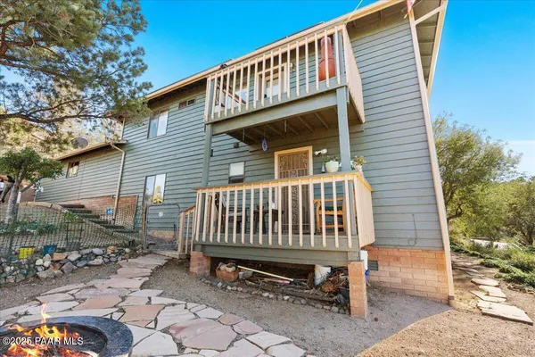 an aerial view of a house with a mountain