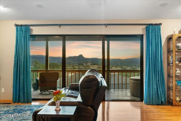 a view of a chairs and table on the balcony