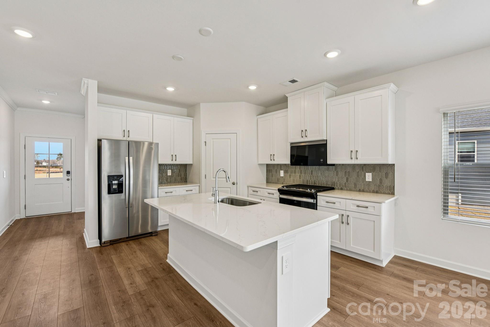 708 Palmer Pendleton Way York, SC 29745 - Photo 7 of 26 a kitchen with refrigerator a sink and wooden floor