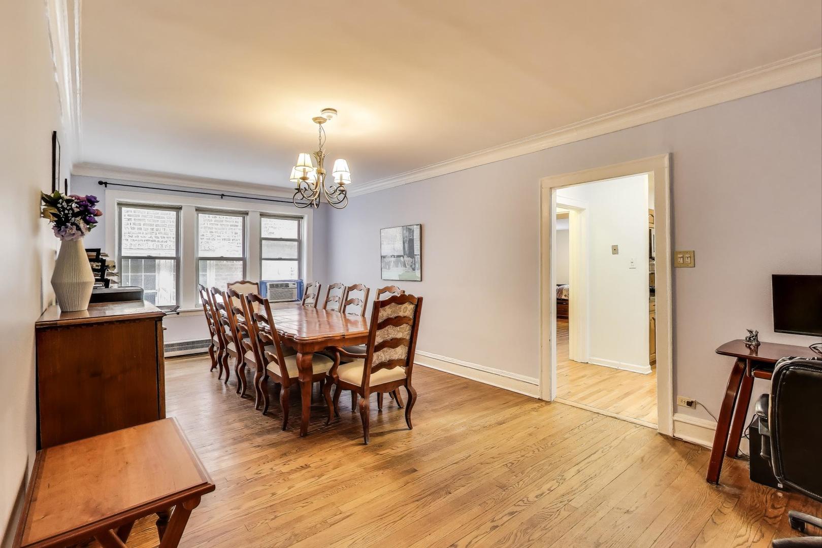 2322 West Farwell Avenue, Unit 1W Chicago, IL 60645 - Photo 13 of 28 a view of a dining room with furniture window and wooden floor