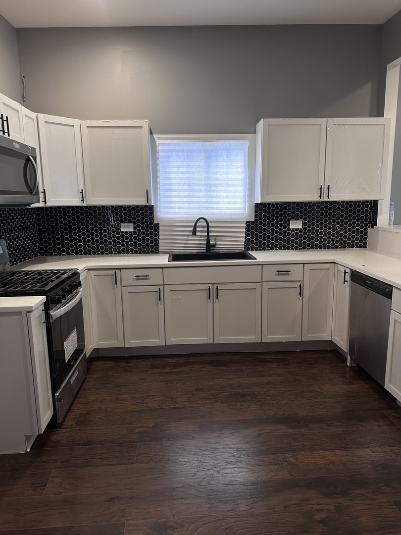6715 South Sangamon Street Chicago, IL 60621 - Photo 11 of 43 a kitchen with granite countertop a sink and cabinets