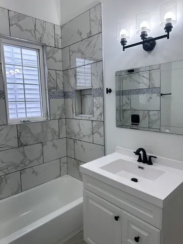 a bathroom with a bathtub and shower