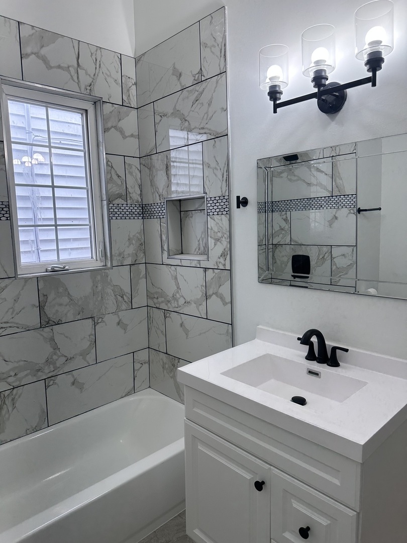 6715 South Sangamon Street Chicago, IL 60621 - Photo 17 of 43 a bathroom with a bathtub and shower