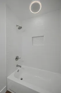 a bathroom with a tub and a sink