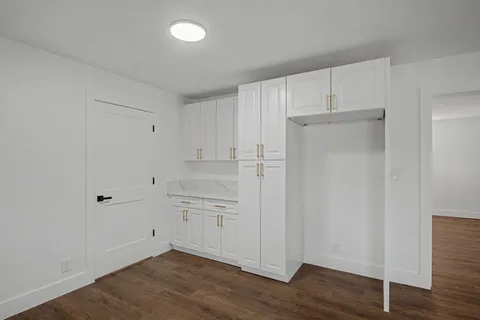 a view of empty room with wooden floor