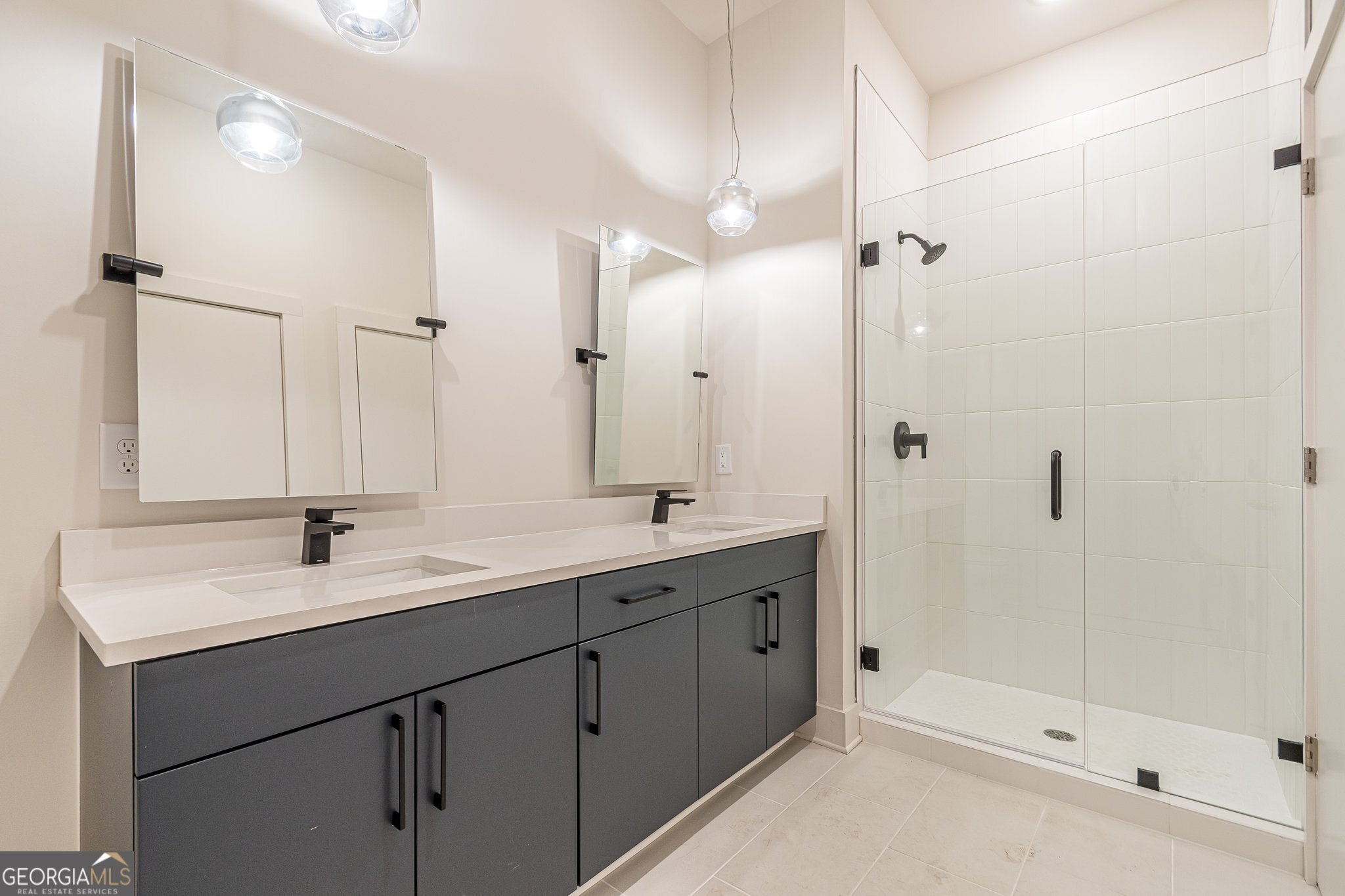 112 Rogers Street Northeast, Unit 601 Atlanta, GA 30317 - Photo 12 of 31 a bathroom with a double vanity sink and mirror