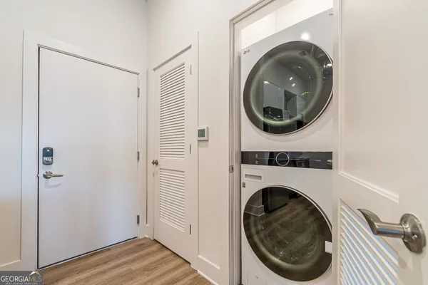 a view of a hallway with washer and dryer