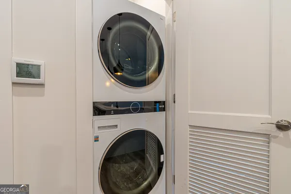 a close up view of a washer and dryer in a small bathroom