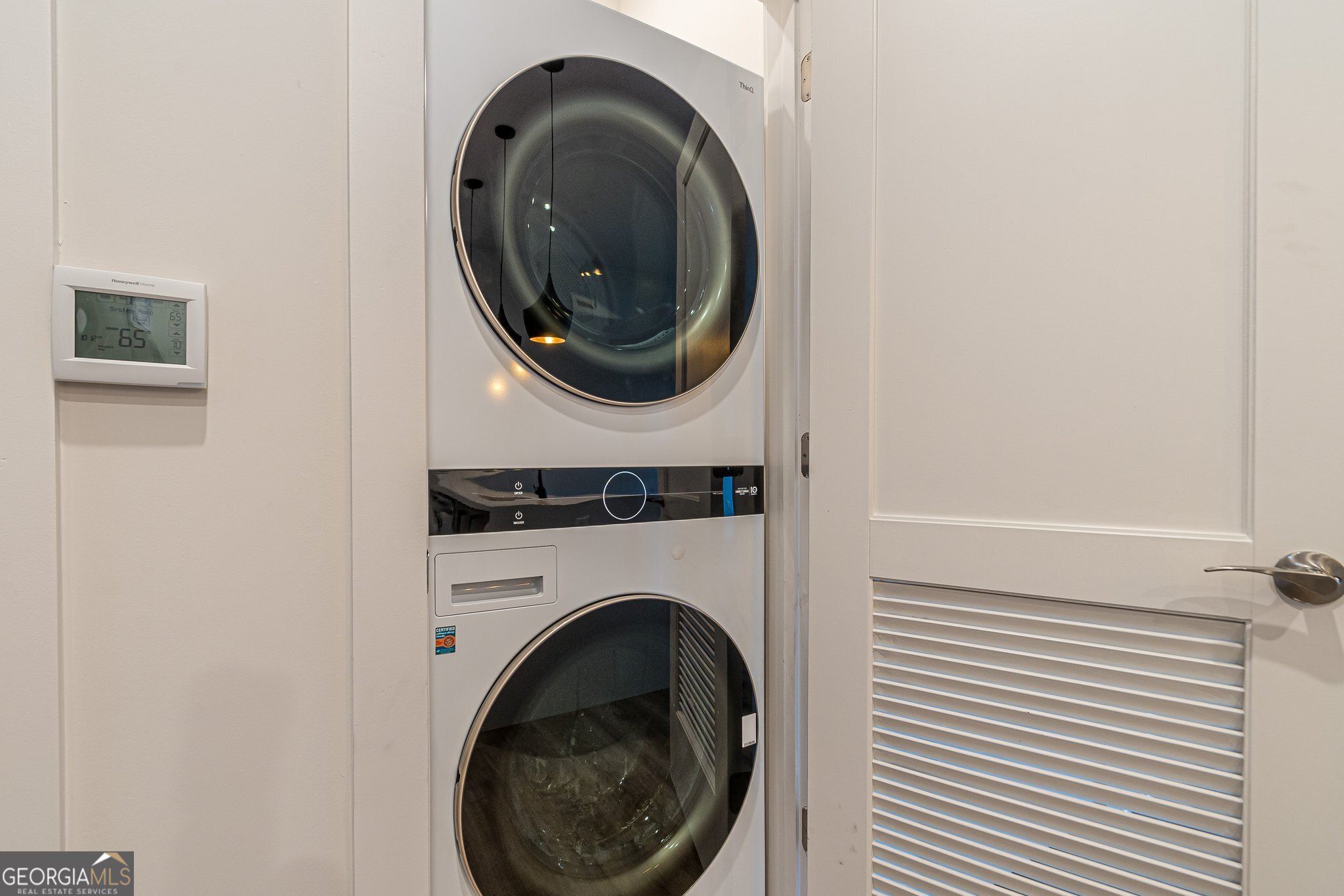 112 Rogers Street Northeast, Unit 601 Atlanta, GA 30317 - Photo 21 of 31 a close up view of a washer and dryer in a small bathroom
