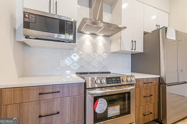 a stove top oven sitting inside of a kitchen