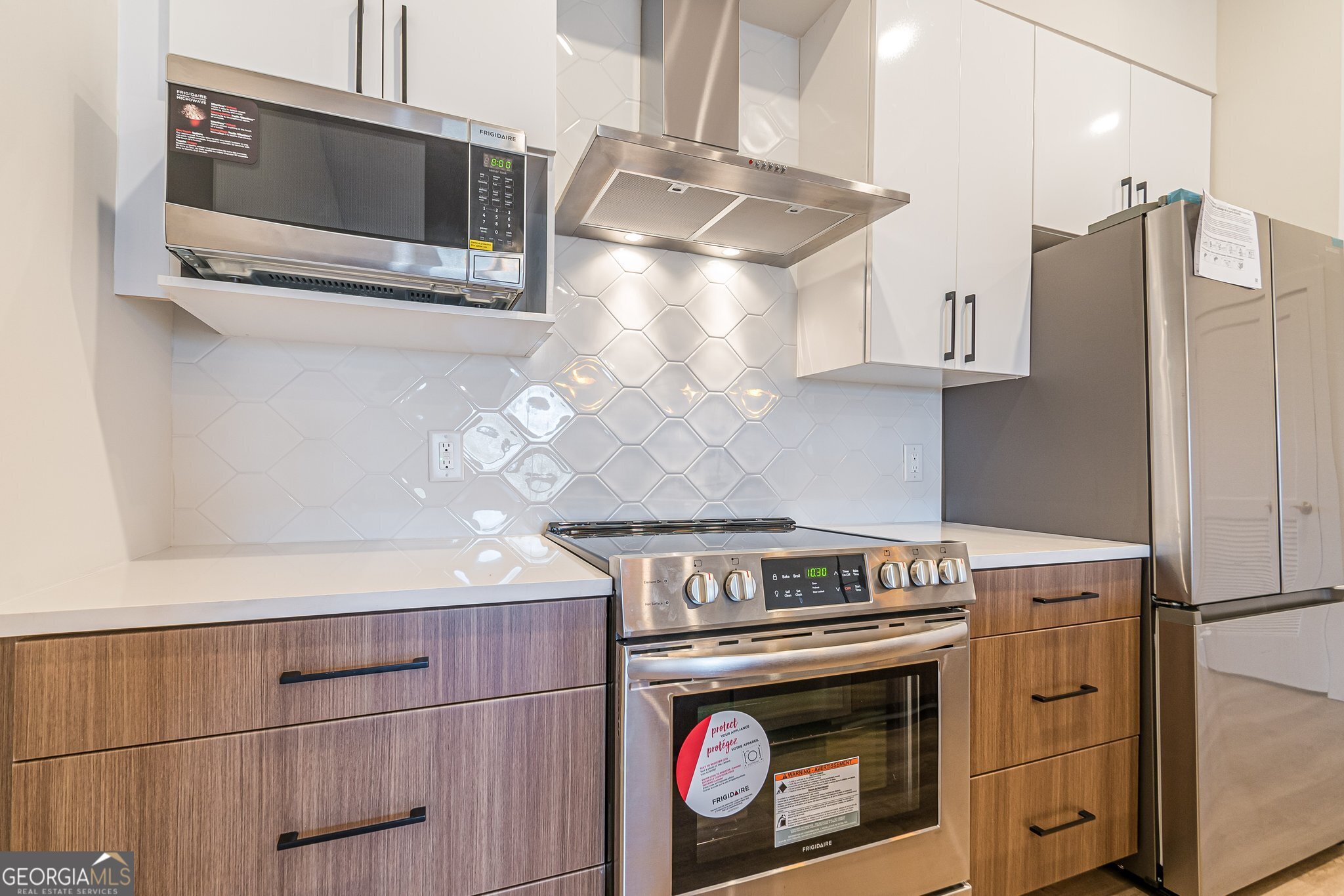112 Rogers Street Northeast, Unit 601 Atlanta, GA 30317 - Photo 3 of 31 a stove top oven sitting inside of a kitchen