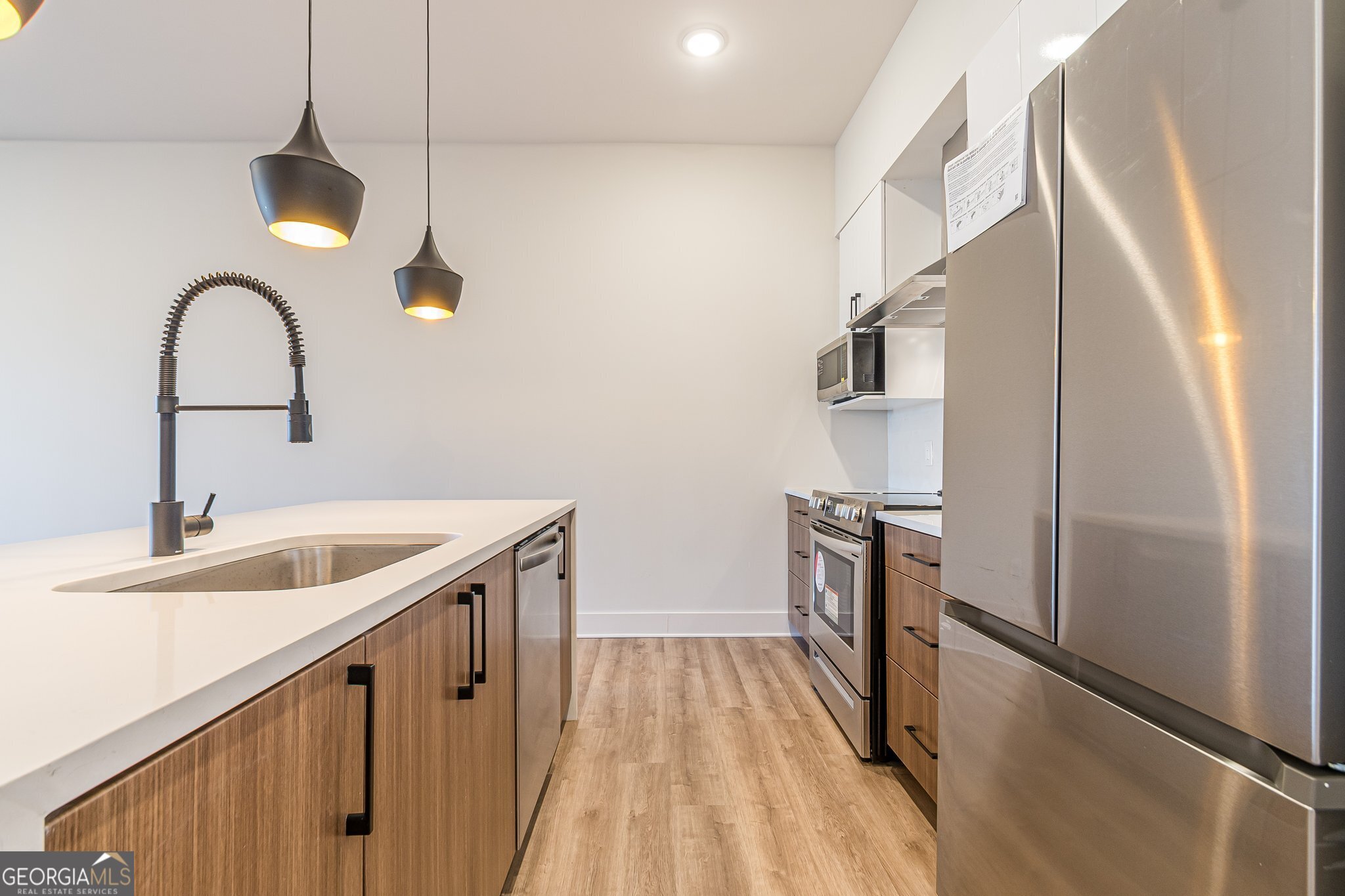 112 Rogers Street Northeast, Unit 601 Atlanta, GA 30317 - Photo 4 of 31 a kitchen with a sink and a refrigerator